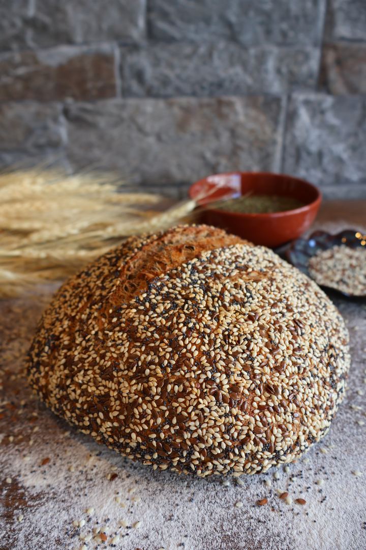Seeded loaf with wheat stalks styled for Kato Edno Vreme bakery, photographed by Wonder Works