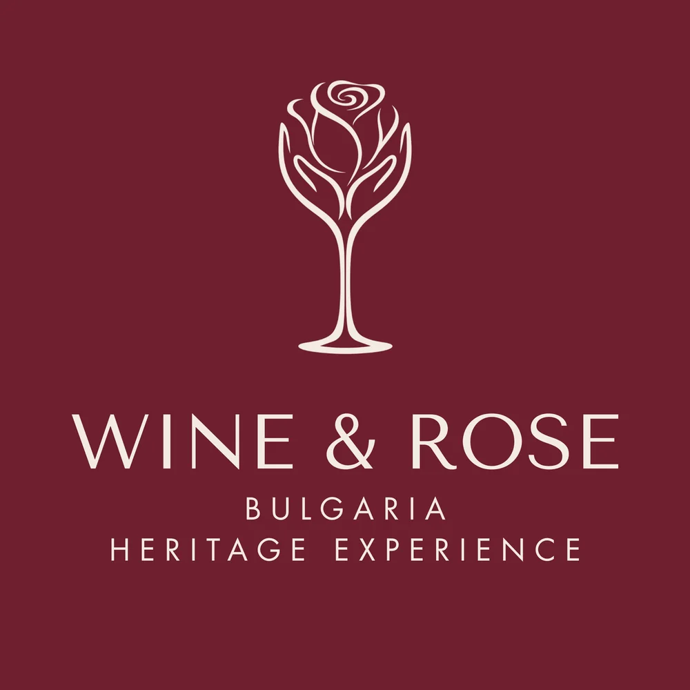 The Wine & Rose logo, a rose growing out of a wine glass, on burgundy