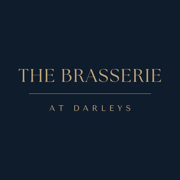 Primary logo for The Brasserie at Darleys, Derby in brass gold on navy, designed by Wonder Works